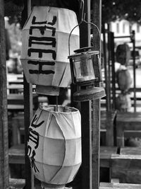 Close-up of lanterns and oil lamp hanging outdoors