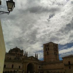 Low angle view of building against cloudy sky