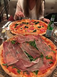 Woman in front of pizza
