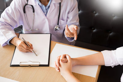 Midsection of man using mobile phone