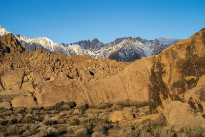 Scenic view of mountains against clear blue sky