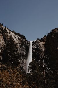 Low angle view of waterfall against sky