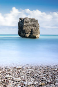 Rocks on beach against sky