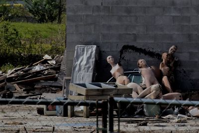 Abandoned mannequins against wall