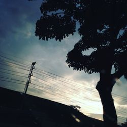 Low angle view of power lines against sky