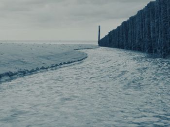 Scenic view of sea against sky during winter