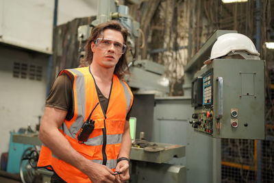 Portrait of male worker standing in the heavy industry manufacturing factory.