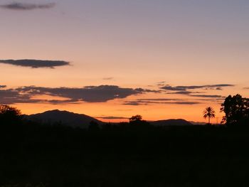 Scenic view of silhouette mountains against sky during sunrise