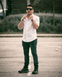 Portrait of young man wearing sunglasses standing outdoors