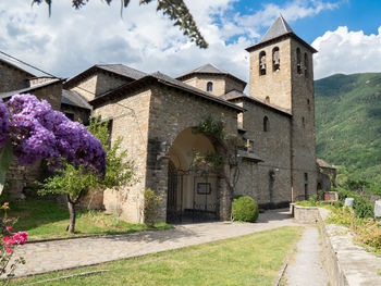 Exterior of historic building by house against sky