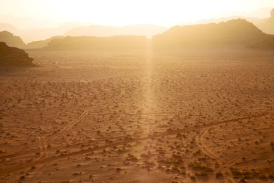 Scenic view of desert against sky during sunset