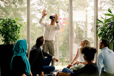 Businessman wearing virtual reality simulator during meeting at convention center