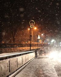 Illuminated street light in city at night