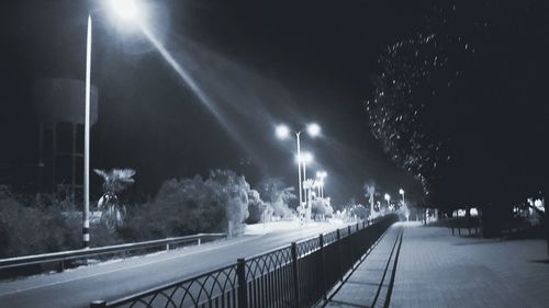 Blurred motion of illuminated lights against sky at night