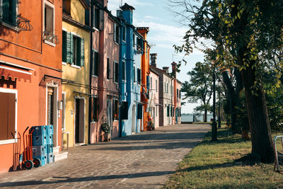 Footpath amidst buildings against sky
