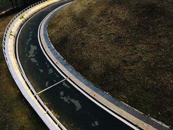 High angle view of railroad track by road in city