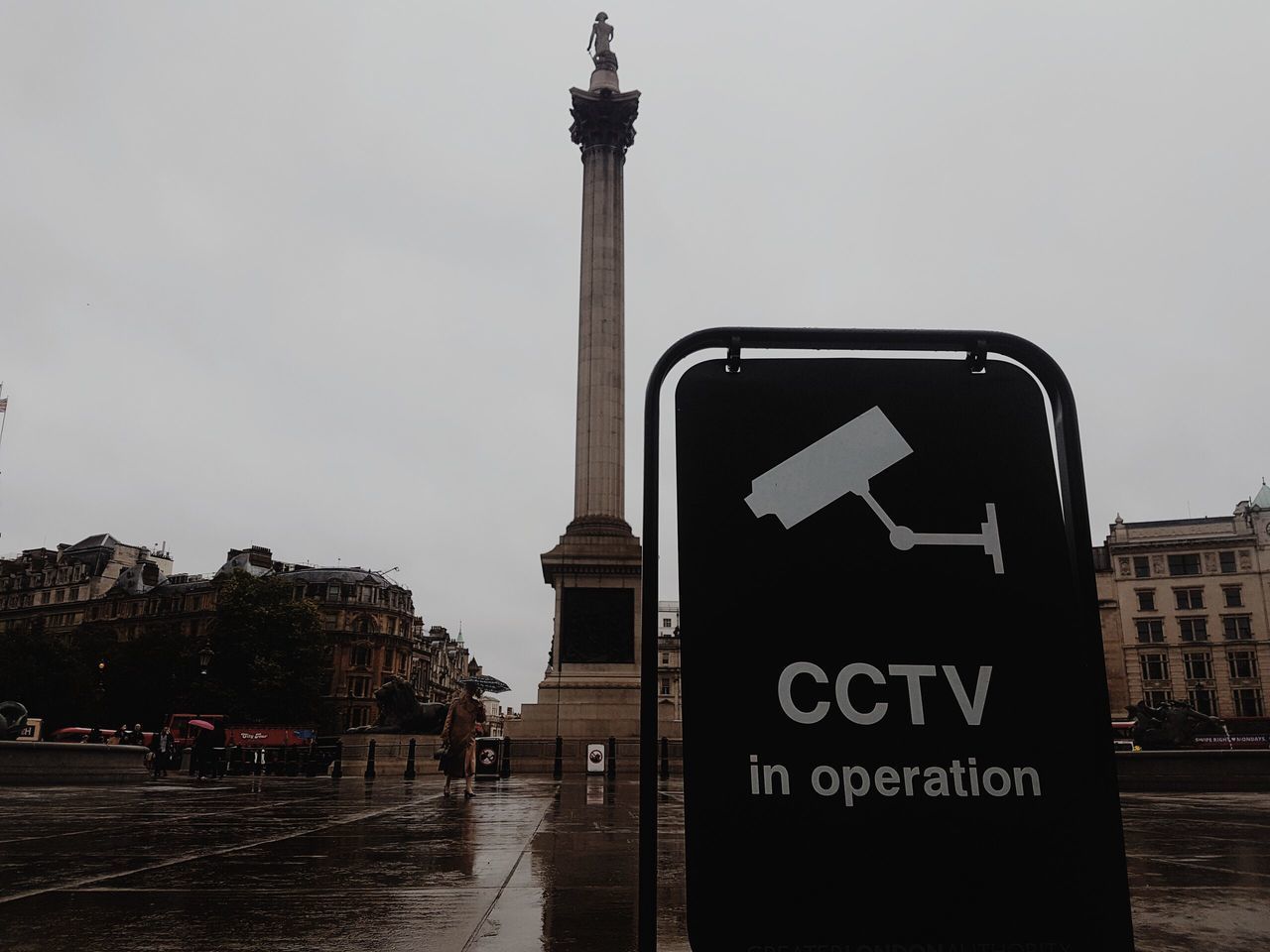 INFORMATION SIGN ON ROAD AMIDST BUILDINGS IN CITY