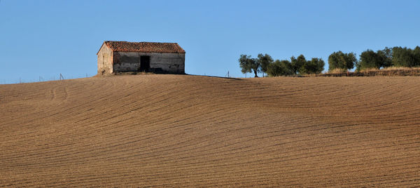 Built structure on field against clear sky