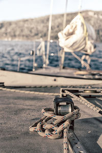 Close-up of rope tied to moored at harbor