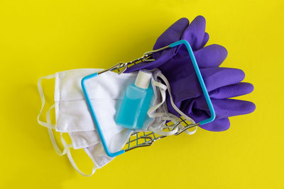 High angle view of blue colored pencils against yellow background