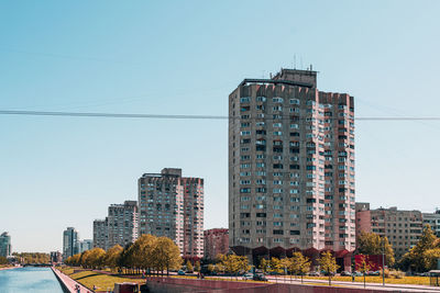 Modern buildings against clear blue sky