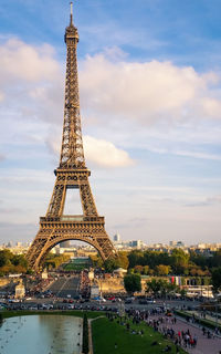 Eiffel tower against cloudy sky in paris. 