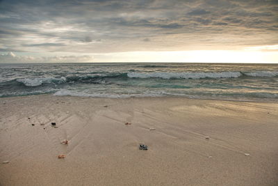 Scenic view of beach against sky during sunset