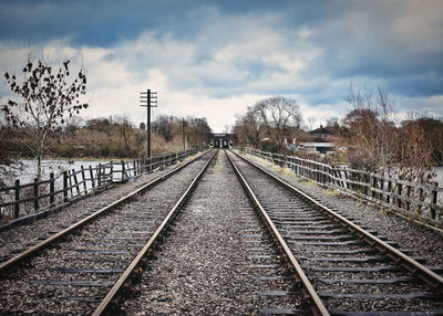 View of railroad tracks against cloudy sky