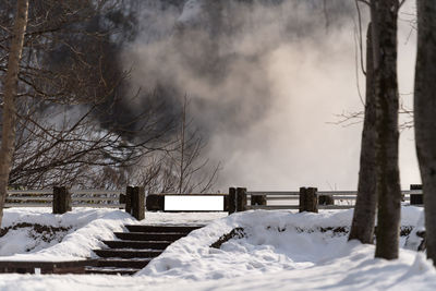 Snow covered field against sky