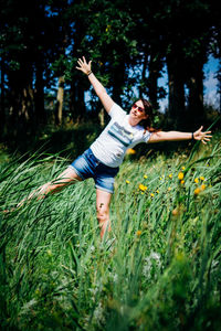 High angle view of young woman standing on grass