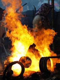 Side view of woman walking by fire