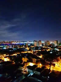 High angle view of illuminated city buildings at night