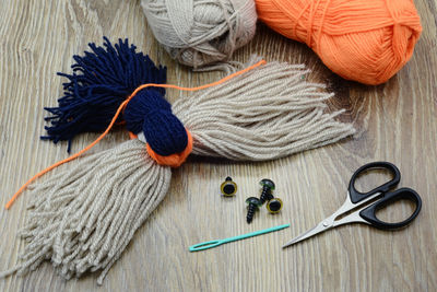 High angle view of wool and scissors on table