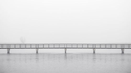 Pier over sea against sky