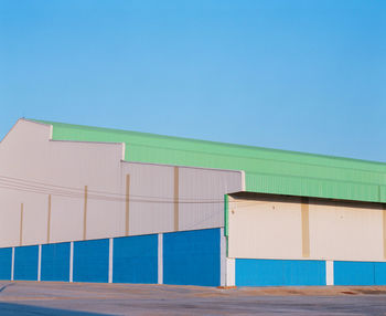 Built structure on beach against clear blue sky