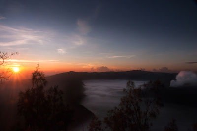 Scenic view of silhouette trees against sky during sunset