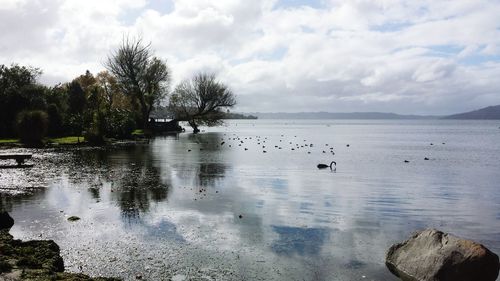 Scenic view of lake against cloudy sky