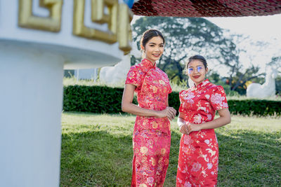 Happy chinese new year. asian woman wearing traditional cheongsam qipao dress.