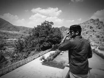 Man standing against landscape