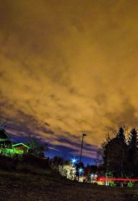 Street light against cloudy sky
