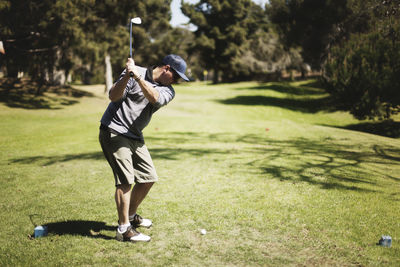 Golfer playing on field at golf club