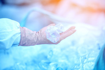 Close-up of human hand holding swimming pool