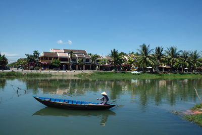 Calm lake with buildings in background