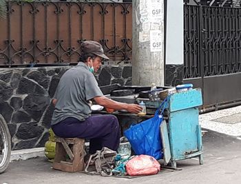 Side view of a man working on building