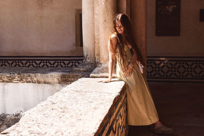 Woman standing against the wall