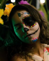 Close-up of woman with face paint during halloween at night