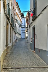 Narrow alley amidst buildings in city