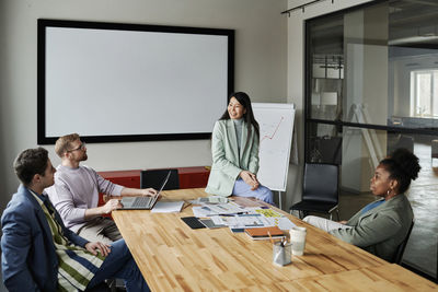 Multi-ethnic group of business colleagues sharing ideas in meeting at office