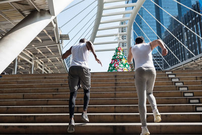 Low angle view of african american black and white people running on staircase