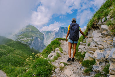 Rear view of man and mountains against sky